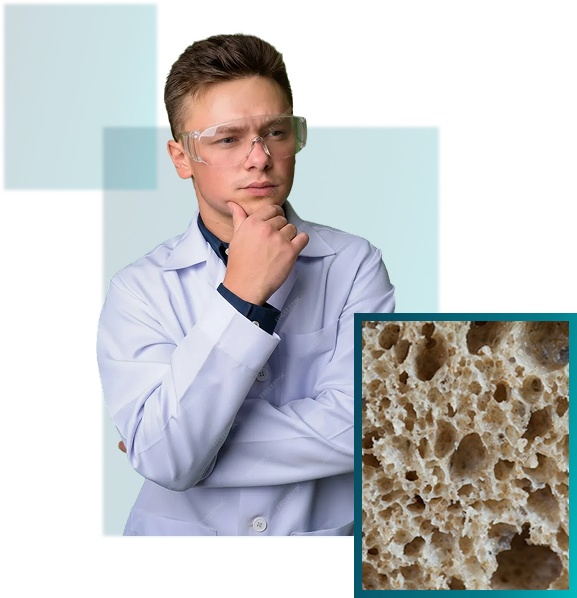 A person in a white lab coat and safety goggles looking thoughtfully at a close-up image of a porous bread texture.